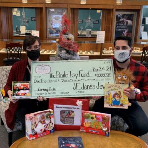 $1000 check donation to The Pirate Toy Fund