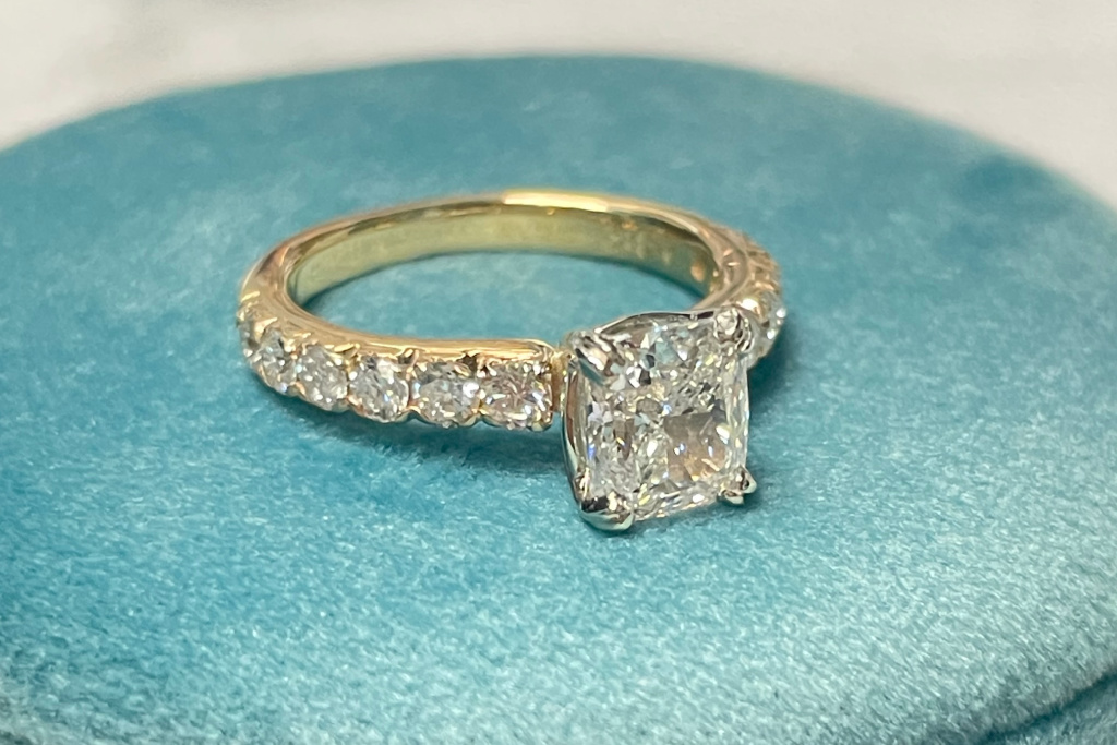 Cushion cut accented engagement ring in yellow gold