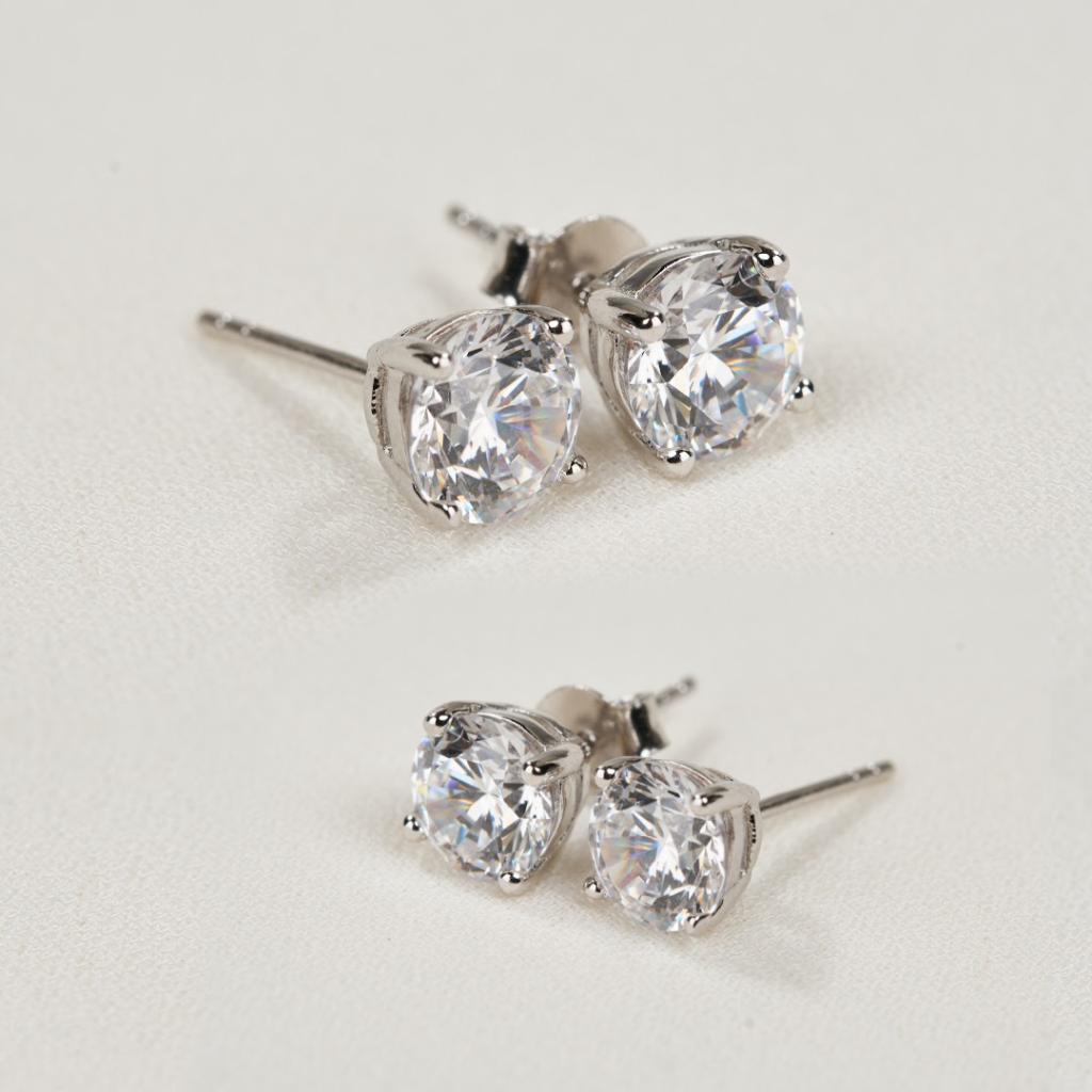 two pairs of diamond stud earrings illustrating JF Jones Jewelers lifetime trade-up program