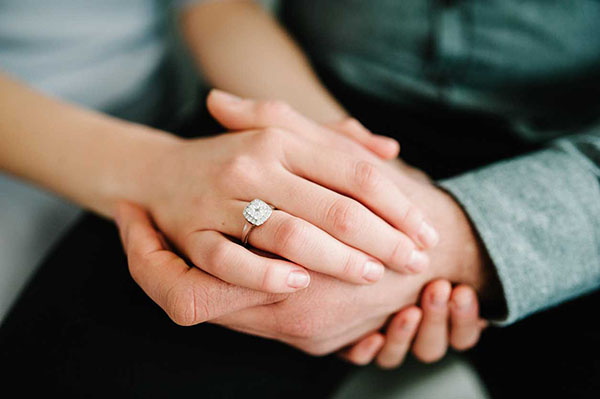 Exquisite diamond engagement ring graces woman's hand